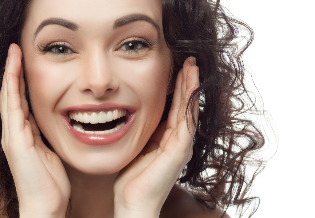 closeup portrait of attractive  caucasian smiling woman brunette - dentist in raleigh